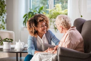 woman providing hospice and palliative care social social work to elderly woman