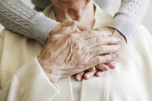 elderly man holding hands with wife after choosing a hospice provider